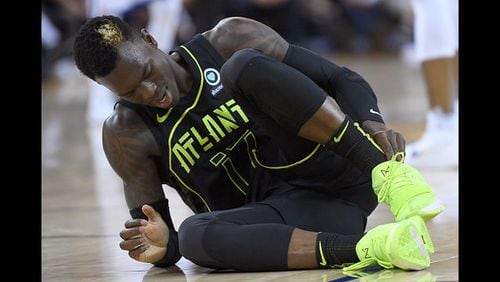 <p>Dennis Schroder #17 of the Atlanta Hawks reacts after twisting his ankle against the Golden State Warriors during an NBA basketball game at ORACLE Arena on March 23, 2018 in Oakland, California.</p>