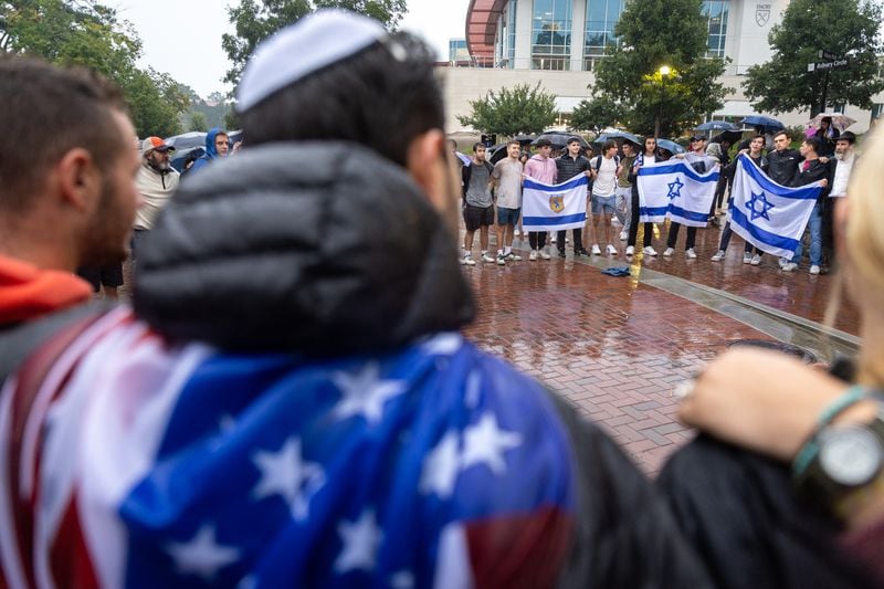Attendees embrace and sing Jewish songs after a vigil for Israel at Emory University in Atlanta on Wednesday, Oct. 11, 2023. The vigil came after Hamas militants waged a surprise attack on Israel. (Arvin Temkar / arvin.temkar@ajc.com)