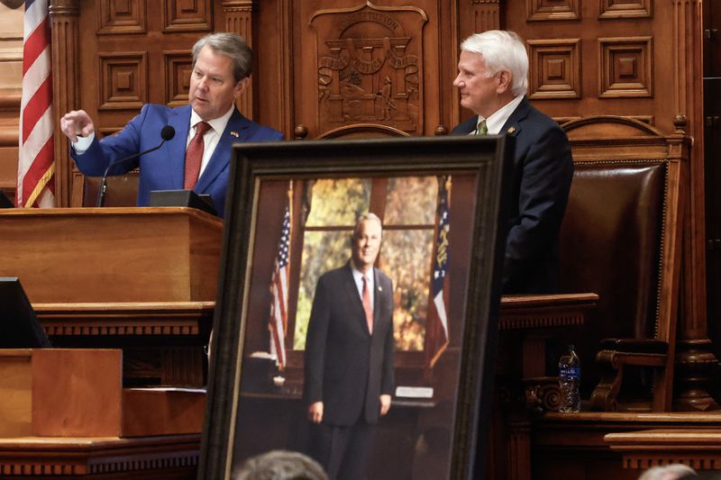 Gov. Brian Kemp gives remarks as Speaker Jon Burns listens after the unveiling of a portrait of the late House Speaker David Ralston at the Capitol in Atlanta on Thursday.