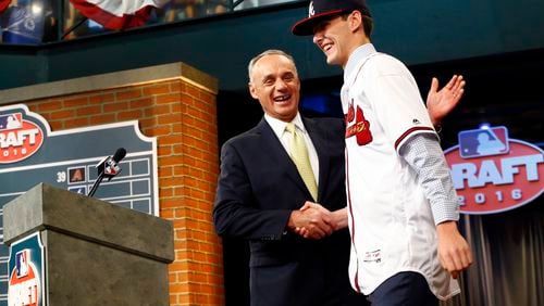Baseball Commissioner Rob Manfred welcomes the Braves top draft pick last year, pitcher Ian Anderson, out of Shenendehowa High School in Clifton Park, N.Y. (AP Photo/Julio Cortez)