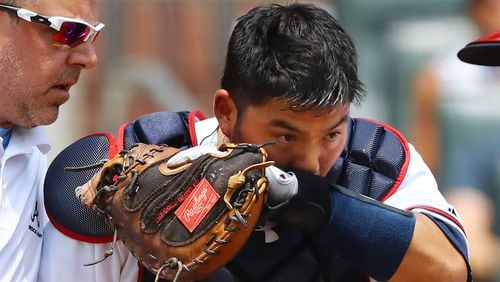 Atlanta Braves catcher Kurt Suzuki leaves the game after getting hit in the head with a bat by San Diego Padres Raffy Lopez during the second inning in a MLB baseball game on Sunday, June 17, 2018, in Atlanta.  Curtis Compton/ccompton@ajc.com
