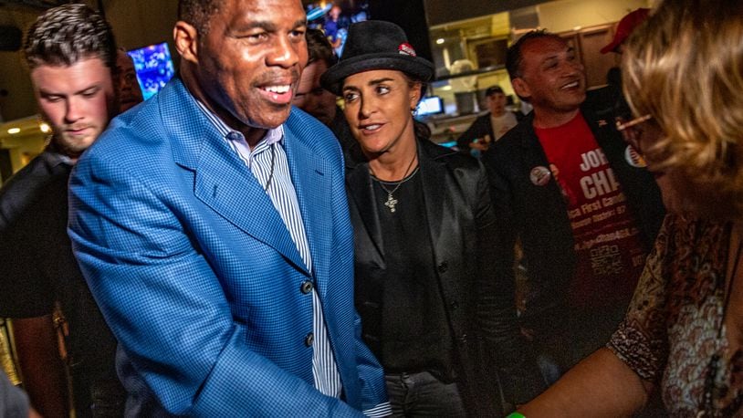 Republican U.S. Senate hopeful Herschel Walker, front left, and his wife, Julie Blanchard, center, leave Mojitos in Norcross after campaigning there in September. Republicans see an opportunity to make gains with Hispanic voters and have stepped up their outreach efforts. (Jenni Girtman for The Atlanta Journal-Constitution)