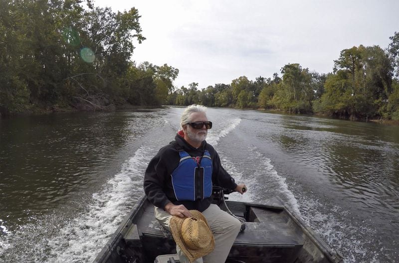 Gordon Rogers, executive director of Flint Riverkeeper, steers a boat on the Flint River near the Mitchell County Line Boat Ramp at the Decatur/Mitchell County line in October. It’s been six years since Florida took its long-running water rights grievances against Georgia to the Supreme Court, and since then the focus of its suit has shifted from metro Atlanta to the farmland of southwest Georgia. (Hyosub Shin / Hyosub.Shin@ajc.com)
