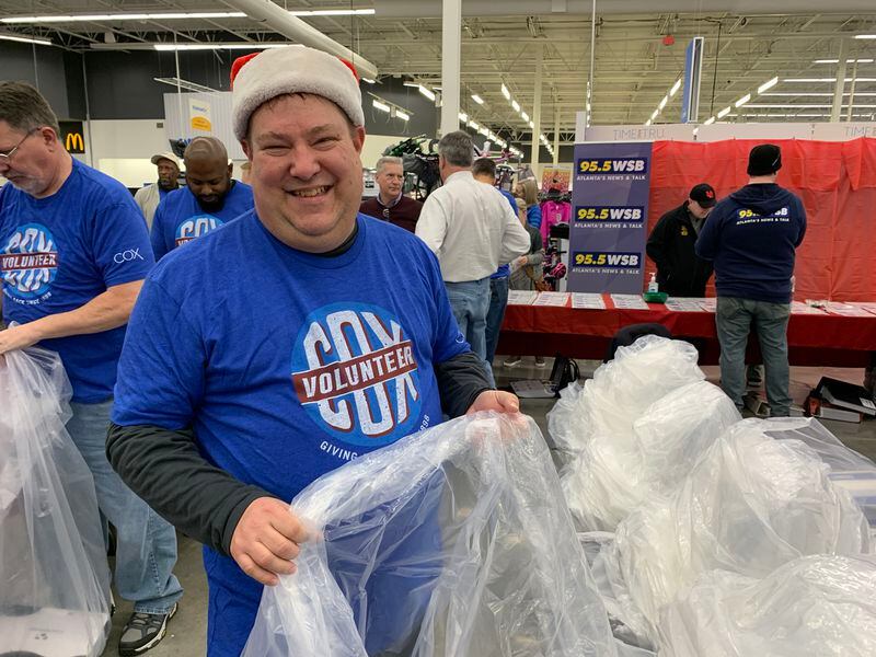 Clark's Christmas Kids volunteer JR Langwell worked at the AJC from 1996 to 2006 as a newspaper hawker. RODNEY HO/rho@ajc.com