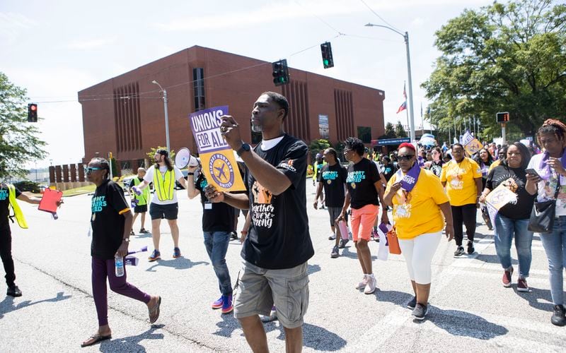 Protesters march from Delta Headquarters during the Airport Workers United march to Delta Headquarters on Saturday, June 3, 2023, in Atlanta. Over 200 protesters marched to demand higher wages. CHRISTINA MATACOTTA FOR THE ATLANTA JOURNAL-CONSTITUTION 