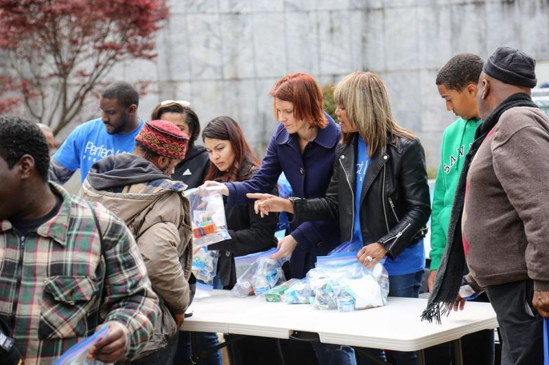 Perfect Love Foundation volunteers distribute water and other items to the homeless. The nonprofit was founded by 32-year-old Taos Wynn of Atlanta. CONTRIBUTED