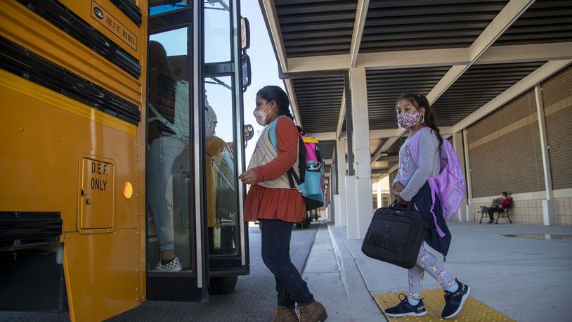 Clarkdale Elementary School students board their school bus at the end the school day. (Alyssa Pointer / Alyssa.Pointer@ajc.com)