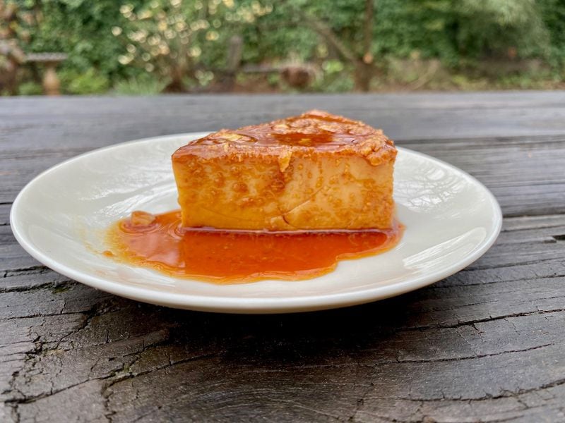 Ozzy Llanes’ mother, Amy, makes the spectacular caramel-sauced flan for Cubanos ATL and delivers it from her nearby home. Wendell Brock for The Atlanta Journal-Constitution
