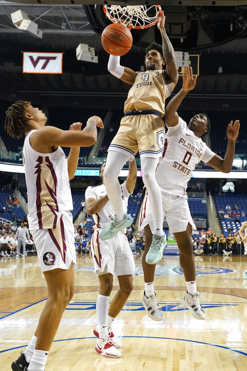 Georgia Tech forward Javon Franklin (4) dunks past Florida State guard Chandler Jackson (0) during the second half of an NCAA college basketball game at the Atlantic Coast Conference Tournament in Greensboro, N.C., Tuesday, March 7, 2023. (AP Photo/Chuck Burton)