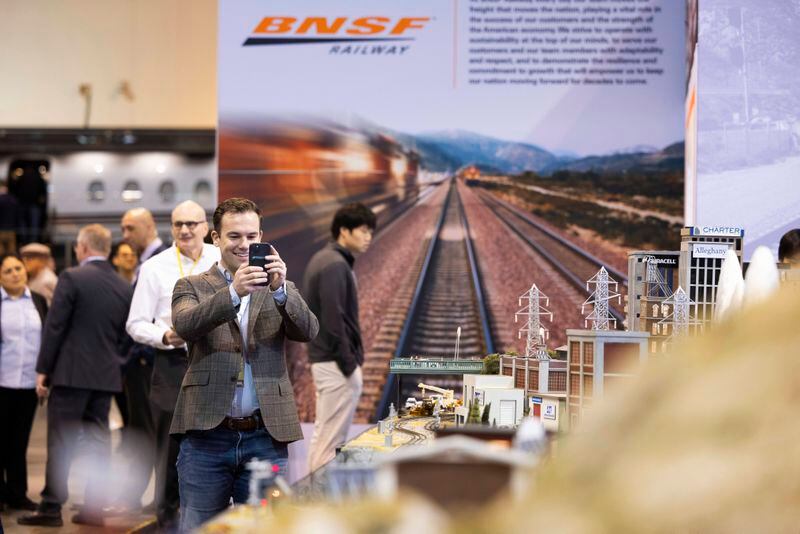 Bart Macdonald of New York City takes photos of the BNSF Railway model train display during the Berkshire Hathaway annual meeting on Saturday, May 4, 2024, in Omaha, Neb. (AP Photo/Rebecca S. Gratz)
