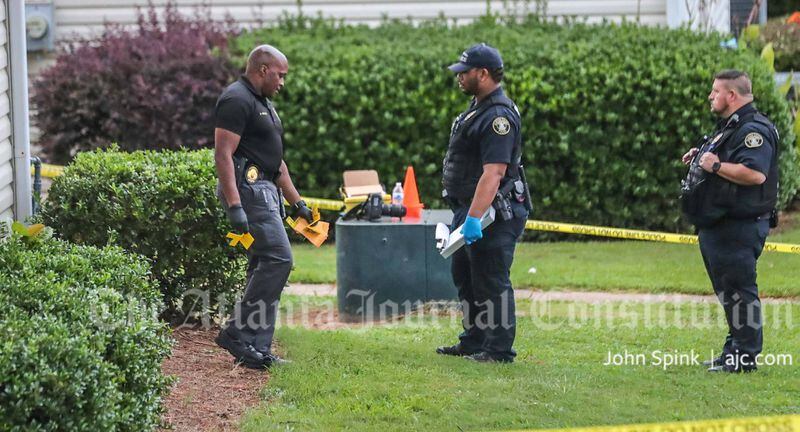 The victims were lying in the front yard of a building at the Riverwood Townhouses on Tuesday morning.