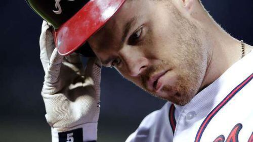Atlanta Braves' Freddie Freeman takes his helmet off as he returns to the dugout after grounding out into a double play in the sixth inning of a baseball game against the Arizona Diamondbacks Friday, May 6, 2016, in Atlanta. The Braves lost 7-2. (AP Photo/David Goldman)