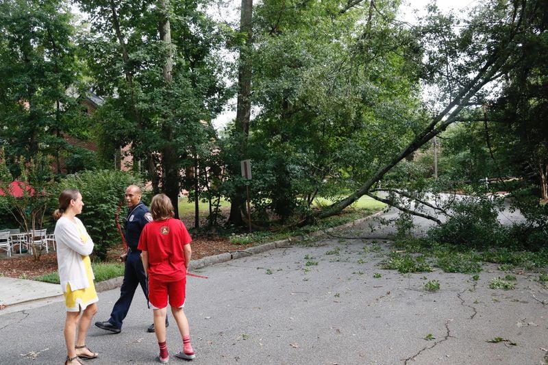 Decatur fire Lt. Justin Sardine puts caution tape around a downed tree and power lines on Mount Vernon Drive in Decatur.
