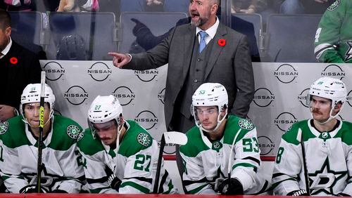 FILE - Dallas Stars' head coach Pete DeBoer, center, shouts instructions to his players against the Winnipeg Jets during the third period of an NHL hockey match in Winnipeg, Manitoba, on Saturday, Nov. 11, 2023. The Stars are heading toward the NHL playoffs with the league's most balanced scoring team. (Fred Greenslade/The Canadian Press via AP, File)