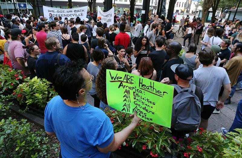 August 13, 2017 Atlanta: Suzanne Marks holds a sign for Heather Heyer as hundreds gather for a anti white nationalism memorial and march in response to violence in Virginia at Woodruff Park on Sunday, August 13, 2017, in Atlanta.    Curtis Compton/ccompton@ajc.com