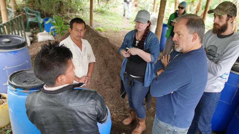  Tripp Pomeroy, right, learns how members of the Fondo Paez co-op of Cauca, Colombia prepare their compost during a 2017 trip there./ Adam Rioux.