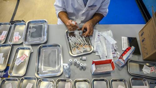 In this file photo, a pharmicist prepares COVID-19 vaccines in New York. (Brittainy Newman/The New York Times)