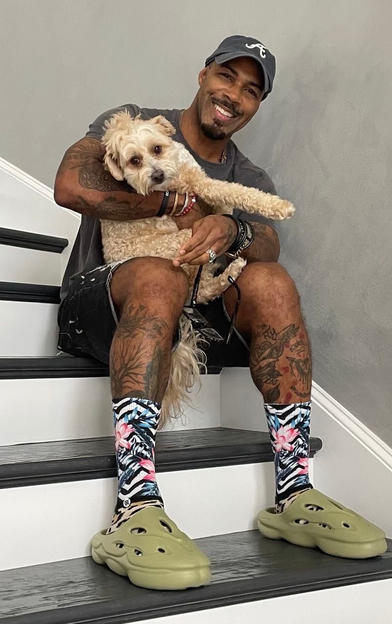 Actor Omari Hardwick with a Braves cap and his dog Boss Baby on Sept. 29, 2023. CONTRIBUTED/Omari Hardwick