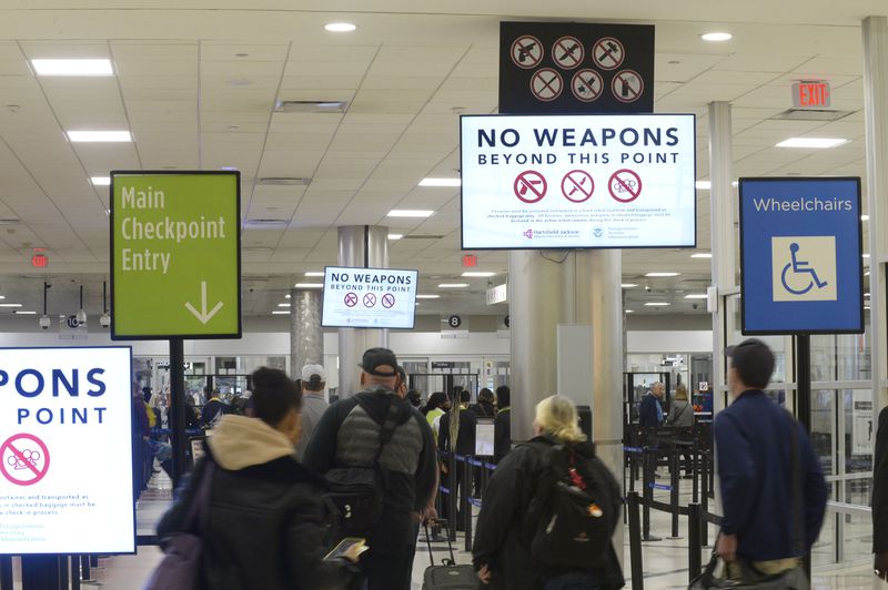 Signs at the main security checkpoint advise passengers against bringing weapons in carry-on luggage Wednesday, April 6, 2022 at Hartsfield-Jackson International Airport. (Daniel Varnado/For the Atlanta Journal-Constitution)