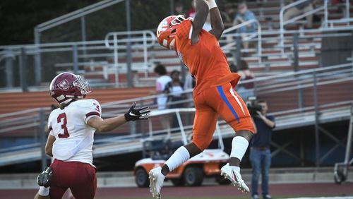 Parkview WR Malik Washington makes a catch in front of Lowndes  LB Tiberius Drocea (3) during a high school football game in Lilburn, Friday August 31, 2018. (John Amis/Special)