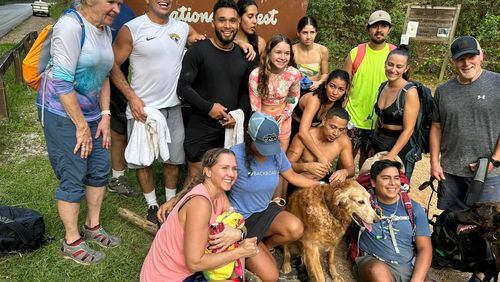 A group of 13 strangers helped the Santanas get their dog, Prince, down the mountain when the dog couldn't finish their hike. Courtesy of Cheryl Hite