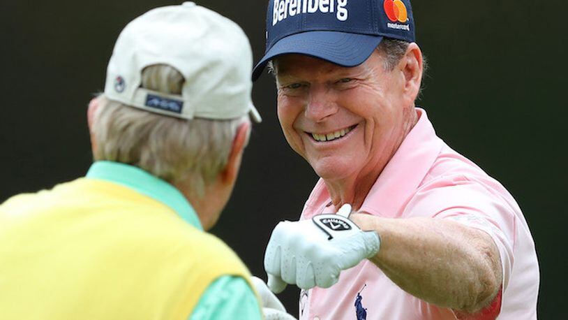 Two-time Masters champion Tom Watson gets a fist bump from six-time Masters champion Jack Nicklaus after sinking a birdie putt on the fourth hole during the Par 3 Contest at Augusta National Golf Club on Wednesday, April 4, 2018, in Augusta, Ga. (Curtis Compton/Atlanta Journal-Constitution/TNS)