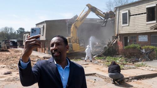 Atlanta Mayor Andre Dickens shoots a video as  demolition work begins on the former Forest Cove Apartments on Wednesday, March 20, 2024.   (Ben Gray / Ben@BenGray.com)