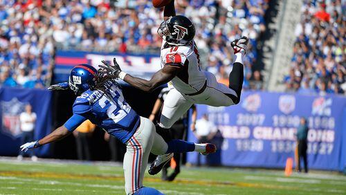 EAST RUTHERFORD, NJ - SEPTEMBER 20: Julio Jones #11 of the Atlanta Falcons makes a first down reception in the fourth quarter under pressure from Brandon Meriweather #22 of the New York Giants at MetLife Stadium on September 20, 2015 in East Rutherford, New Jersey. The Atlanta Falcons defeated the New York Giants 24-20. (Photo by Alex Goodlett/Getty Images)