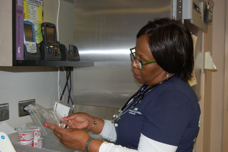 Velma Blackwell reviews and verifies patient medications during her shift at Northside Hospital Cherokee. CONTRIBUTED