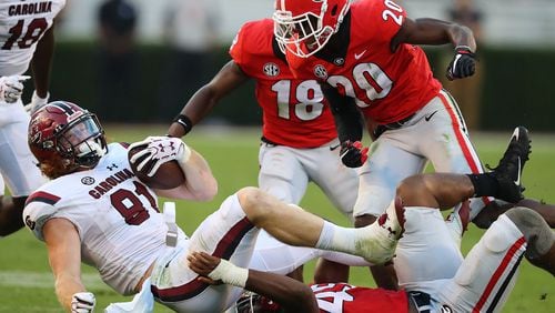 Georgia linebacker Reggie Carter tackles South Carolina tight end Hayden Hurst during the second half in a NCAA college football game on Saturday, November 4, 2017, in Athens.    Curtis Compton/ccompton@ajc.com