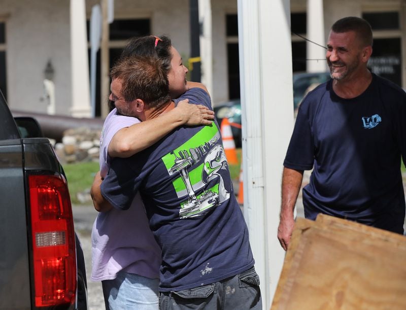 St. Marys store owner Angie Mock gets a hug from Ryan Trotter as family and friends arrive to help her evacuate her Market on the Square business in preparation for Hurricane Dorian. (Photo: Curtis Compton/ccompton@ajc.com)