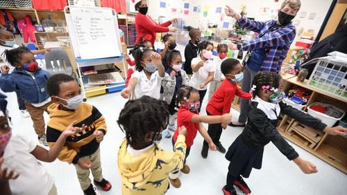 Lori Gardner, a pre-k teacher at Kemp Primary School  in Clayton County, dances with her pre-K class at the start of the school day. Denise Stevens, the school's principal, dances in the back of the class.
Thursday, December 16, 2021. Miguel Martinez for The Atlanta Journal-Constitution