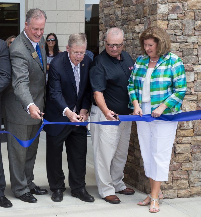 U.S. Sen. Johnny Isakson (third from the right) and U.S. Rep. Karen Handel, whose Sixth District includes part of East Cobb (far right) and other dignitaries cut the ribbon for the grand opening of the newly completed first phase of construction of Walton High School.
