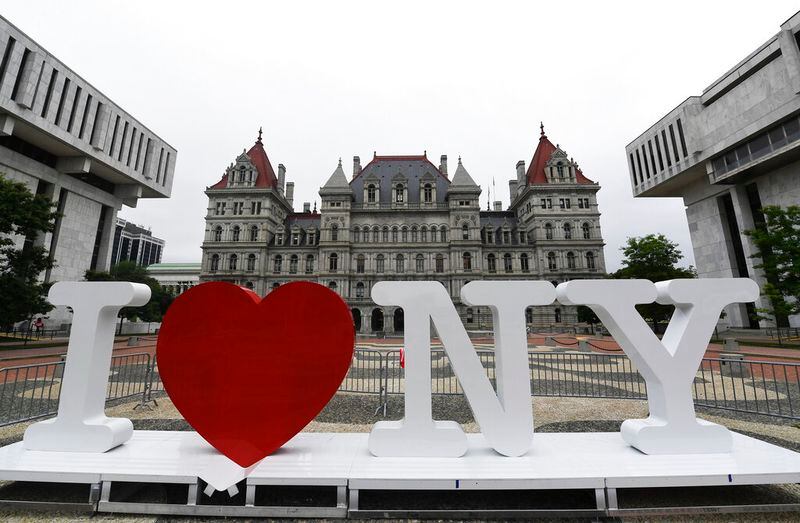 FILE - In this Tuesday, June 18, 2019, file photo, a new promotional "I Love NY" sign sits in the Empire State Plaza for installation in front of the New York state Capitol in Albany, N.Y. Milton Glaser, the designer who created the "I (HEART) NY" logo and the famous Bob Dylan poster with psychedelic hair, died Friday, June 26, 2020, his 91st birthday. (AP Photo/Hans Pennink, File)