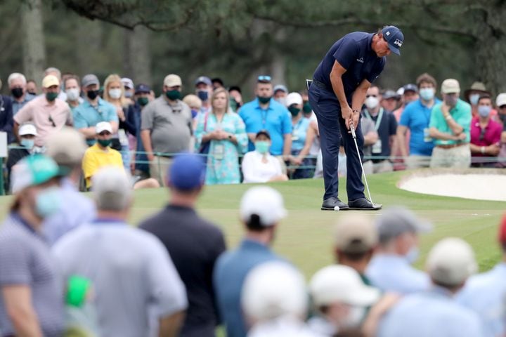 April 10, 2021, Augusta: Patrons watch as Phil Mickelson putts on the seventh green during the third round of the Masters at Augusta National Golf Club on Saturday, April 10, 2021, in Augusta. Curtis Compton/ccompton@ajc.com