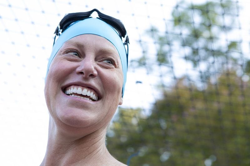 Feeling a mix of emotions, Vicki Bunke smiles before the start of the 1-mile swim at Swim Across America’s 2018 Atlanta Open Water Swim event at Lake Lanier in Buford. CASEY SYKES / FOR THE ATLANTA JOURNAL-CONSTITUTION