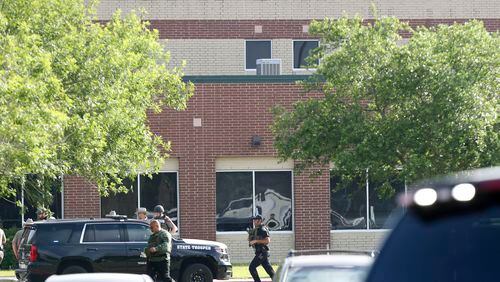Law enforcement officers respond to Santa Fe High School after an active shooter was reported on campus, Friday, May 18, 2018, in Santa Fe, Texas. ( Steve Gonzales/Houston Chronicle via AP)