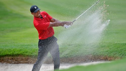 Tiger Woods saves par from the sand on No. 5 on the way to Tour Championship victory. (HYOSUB SHIN / HSHIN@AJC.COM)