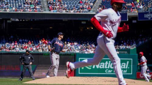Braves starting pitcher Jared Shuster (left) watches after walking in a run during the first inning of a baseball game against the Washington Nationals at Nationals Park, Sunday, April 2, 2023, in Washington.