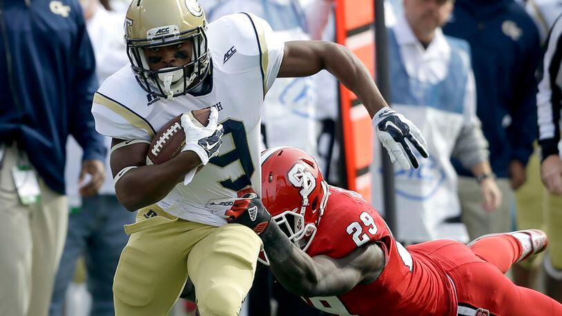 North Carolina State's Jack Tocho (29) dives as Georgia Tech's Tony Zenon (9) runs the ball during the first half of an NCAA college football game in Raleigh, N.C., Saturday, Nov. 8, 2014. (AP Photo/Gerry Broome)