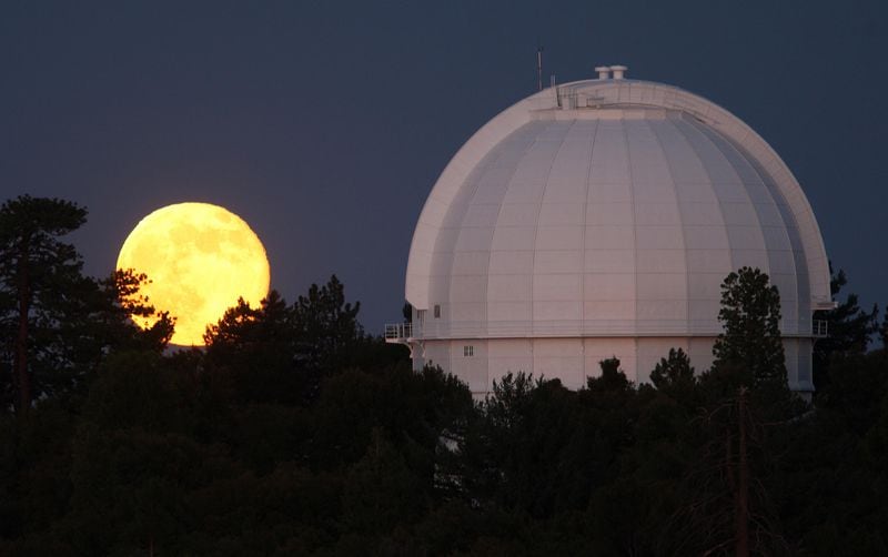 A supermoon, or perigee moon, rises behind the historic Mount Wilson Observatory on July 12, 2014 at Mount Wilson in the Angeles National Forest northeast of Los Angeles, California. The observatory founded by George Hale houses the 60-inch Hale telescope, built in 1908, and formerly world's largest, 100-inch Hooker telescope built in 1917. The perigree moon appears slightly brighter and larger on its closest orbits to the earth.