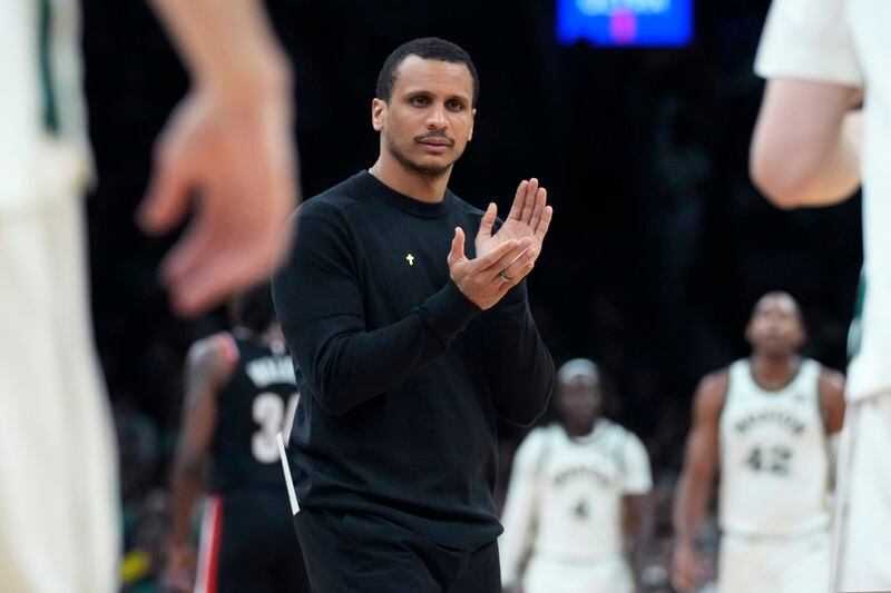 Boston Celtics head coach Joe Mazzulla applauds as his players head to the bench during a timeout in the first half of an NBA basketball game, Sunday, April 7, 2024, in Boston. (AP Photo/Charles Krupa)