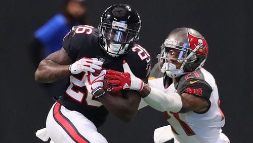 Falcons running back Tevin Coleman makes a first down gain during the second half against the Buccaneers in a NFL football game on Sunday, November 26, 2017, in Atlanta.   Curtis Compton/ccompton@ajc.com