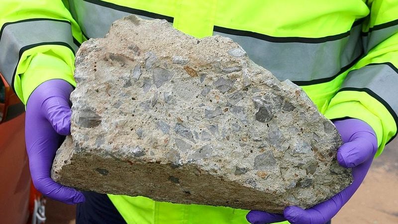 In this photo released by the Nashville Police, an officer holds large piece of concrete that struck a vehicle on Interstate 24, Tuesday, Nov. 20, 2018, in Nashville, Tenn. police believe a piece of concrete may have been thrown from an overpass and are looking for witnesses who may have seen it happen.