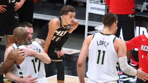 Hawks guard Trae Young is alone with his thoughts as the Milwaukee Bucks celebrate their 118-107 victory in Game 6 of the NBA Eastern Conference Finals, as they advance to play for a championship.   “Curtis Compton / Curtis.Compton@ajc.com”
