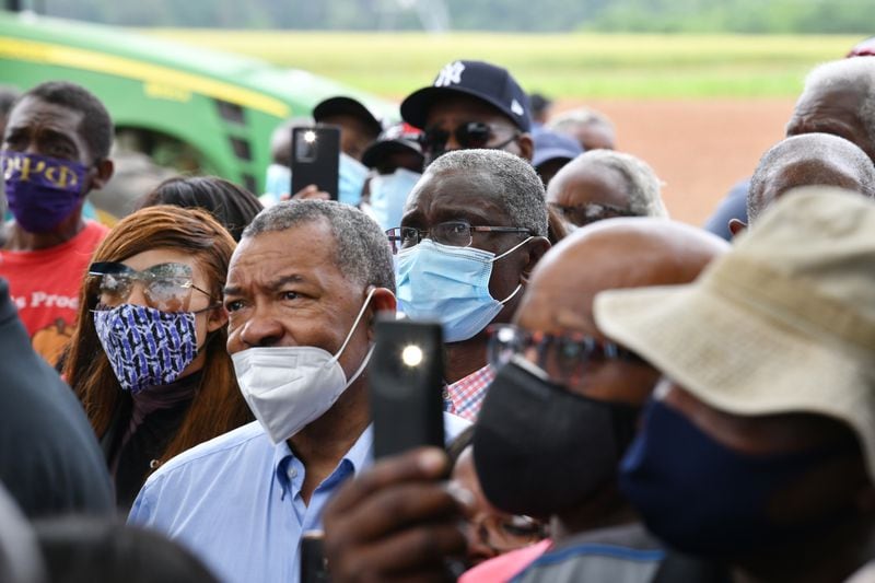 Black farmers react as U.S. Sen. Raphael Warnock speaks to them. “We’ve got confidence in him — but we aren’t playing around in Georgia,” one of the farmers said. (Hyosub Shin / Hyosub.Shin@ajc.com)