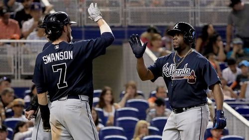 Adonis Garcia of the Atlanta Braves is congratulated after hitting a three run home run in the seventh inning during a game against the Miami Marlins at Marlins Park on October 1, 2017 in Miami, Florida.  (Photo by Mike Ehrmann/Getty Images)