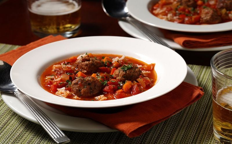 A meatball soup takes on the flavors of stuffed peppers. It's made with beef and Italian sausage meatballs in chicken broth, plus tomatoes, bell peppers, white beans, rice and fresh herbs. (Mark Graham/food styling) (E. Jason Wambsgans/Chicago Tribune/TNS)