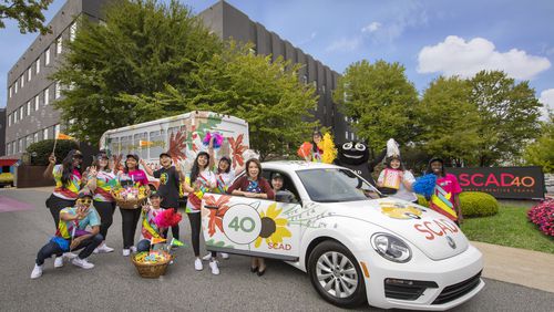 SCAD President and Founder Paula Wallace and student ambassadors celebrate the university’s 40th anniversary on SCAD Day —an open house for hundreds of prospective students from around the world. The VW Bug pictured here was designed by SCAD graduate Emily Isabella (B.F.A., fibers, 2008).