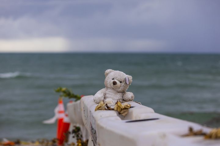 A stuffed animal rests on a barricade on the beach near the collapsed Champlain Towers South condominium, in Surfside, Fla., on Wednesday July 7, 2021. (Saul Martinez/The New York Times)